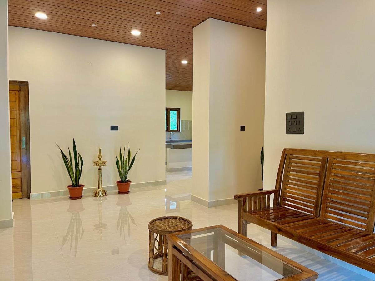Ground-floor lobby with a brass oil lamp between two potted snake plants
