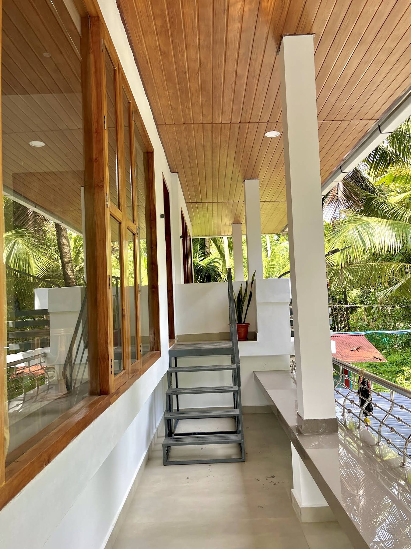The upper verandah running the length of the house, teak soffit overhead